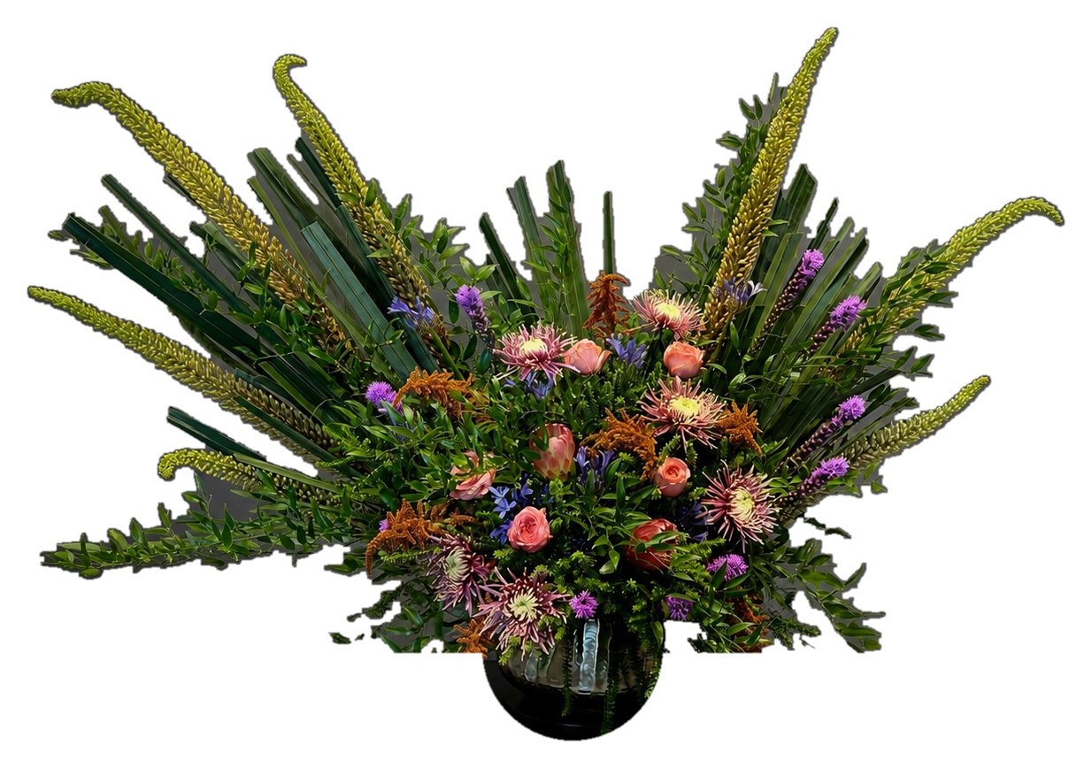 Large sculptural floral centerpiece with deep red and gold flowers