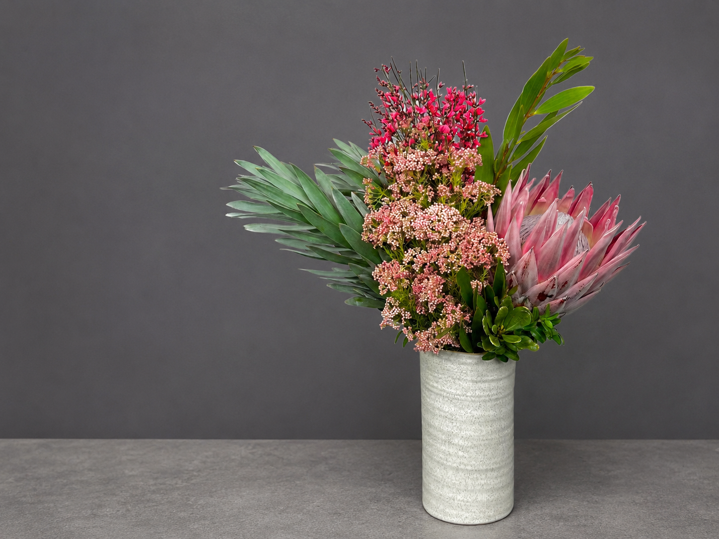 Long low floral arrangement for a counter or reception desk